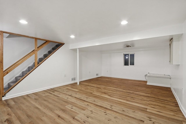 32 Woodridge Ln, Streamwood, IL 60107 - finished basement with stairs, light wood-style flooring, and recessed lighting