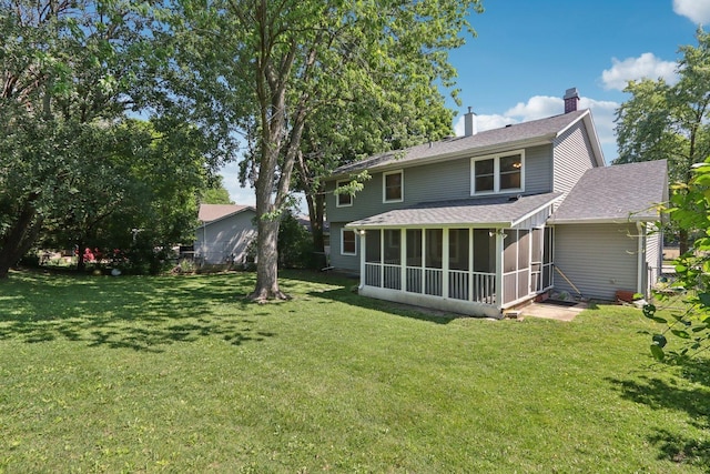 32 Woodridge Ln, Streamwood, IL 60107 - back of house featuring a sunroom, a yard, roof with shingles, and a chimney
