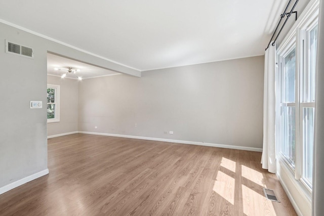 32 Woodridge Ln, Streamwood, IL 60107 - spare room featuring light wood-type flooring and crown molding