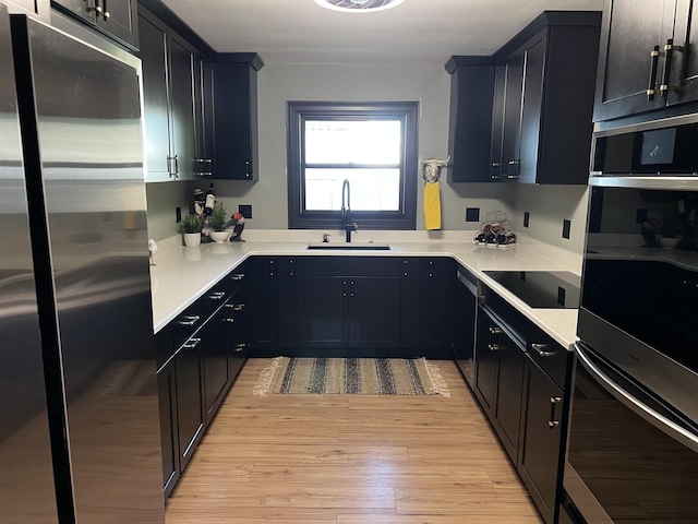 5 Knollcrest Ct, Normal, IL 61761 - kitchen with stainless steel appliances, light wood-type flooring, light countertops, and dark cabinetry