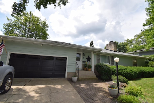 5 Knollcrest Ct, Normal, IL 61761 - ranch-style house featuring concrete driveway, an attached garage, and a chimney