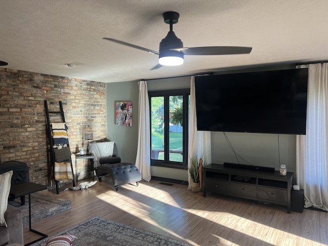 5 Knollcrest Ct, Normal, IL 61761 - living room featuring a textured ceiling, a ceiling fan, wood finished floors, and a wood stove