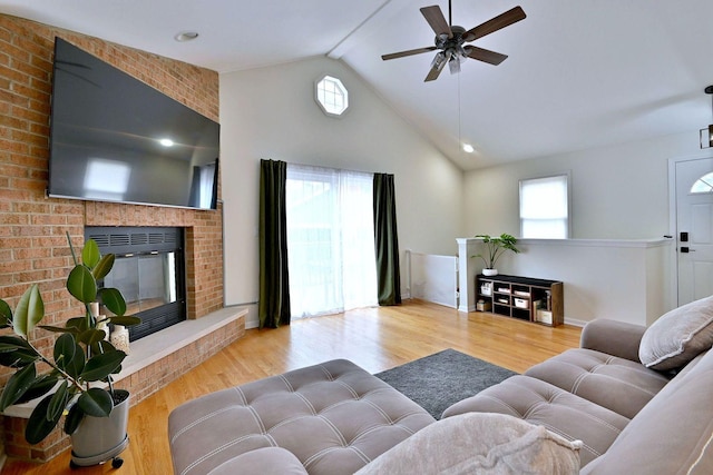1747 Linneman St, Glenview, IL 60025 - living room featuring healthy amount of natural light, a ceiling fan, wood finished floors, high vaulted ceiling, and a brick fireplace