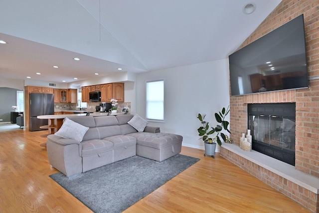 1747 Linneman St, Glenview, IL 60025 - living room with lofted ceiling, light wood-type flooring, healthy amount of natural light, a fireplace, and recessed lighting