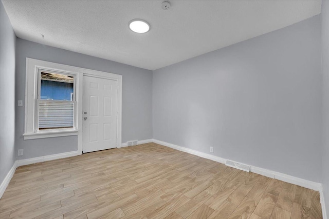 305 S Lewis Ave, Waukegan, IL 60085 - empty room with light wood-style floors and a smoke detector