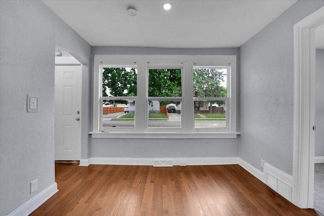 305 S Lewis Ave, Waukegan, IL 60085 - empty room featuring wood finished floors, a textured wall, and a smoke detector