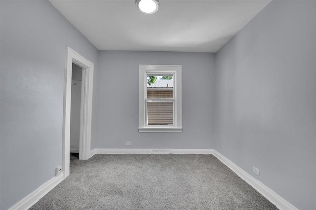 305 S Lewis Ave, Waukegan, IL 60085 - carpeted empty room with baseboards