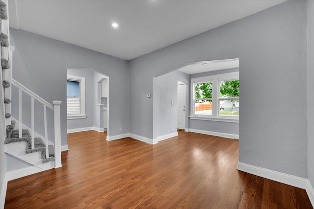305 S Lewis Ave, Waukegan, IL 60085 - unfurnished room featuring wood finished floors, stairs, and arched walkways