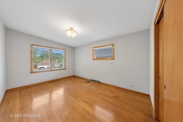 506 S Charleton St, Willow Springs, IL 60480 - unfurnished bedroom with a closet and light wood-style flooring