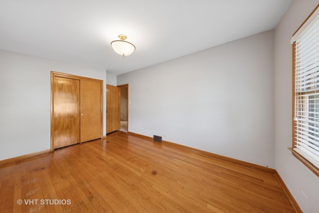 506 S Charleton St, Willow Springs, IL 60480 - unfurnished bedroom with light wood-style floors and a closet