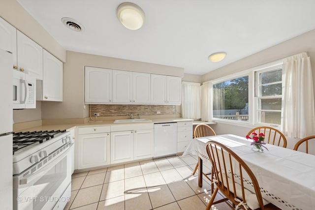 506 S Charleton St, Willow Springs, IL 60480 - kitchen with white appliances, white cabinetry, tasteful backsplash, light countertops, and light tile patterned floors