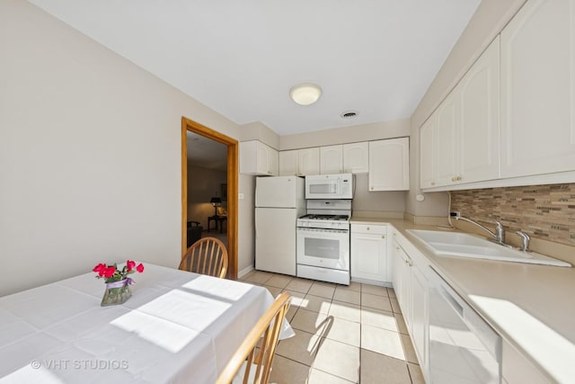 506 S Charleton St, Willow Springs, IL 60480 - kitchen featuring white appliances, backsplash, white cabinets, light tile patterned flooring, and light countertops