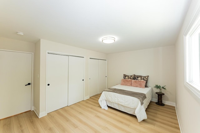 570 Dawes Ave, Glen Ellyn, IL 60137 - bedroom featuring two closets and light wood-type flooring