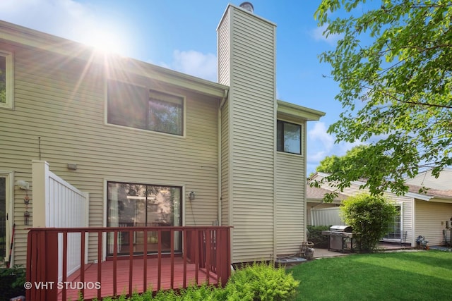 1410 N Whispering Springs Cir, Palatine, IL 60074 - rear view of house featuring a chimney, a lawn, and a deck