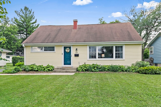 49 Burton Ave, Cary, IL 60013 - view of front of home featuring a chimney, a front lawn, and a shingled roof
