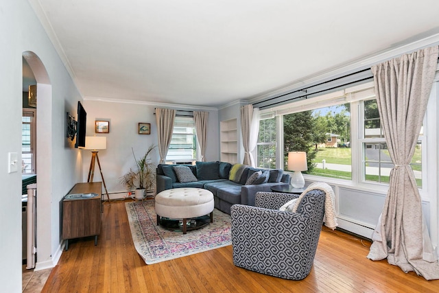 49 Burton Ave, Cary, IL 60013 - living area featuring ornamental molding, arched walkways, light wood finished floors, a baseboard radiator, and baseboard heating
