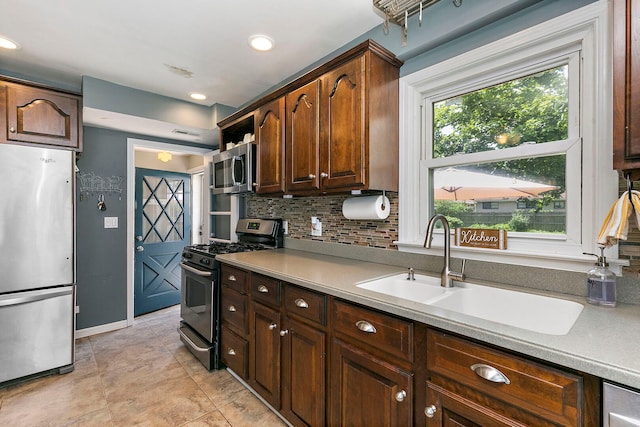 49 Burton Ave, Cary, IL 60013 - kitchen featuring stainless steel appliances, tasteful backsplash, light countertops, light tile patterned floors, and recessed lighting