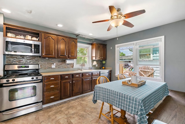 49 Burton Ave, Cary, IL 60013 - kitchen with appliances with stainless steel finishes, decorative backsplash, light countertops, a ceiling fan, and dark brown cabinetry