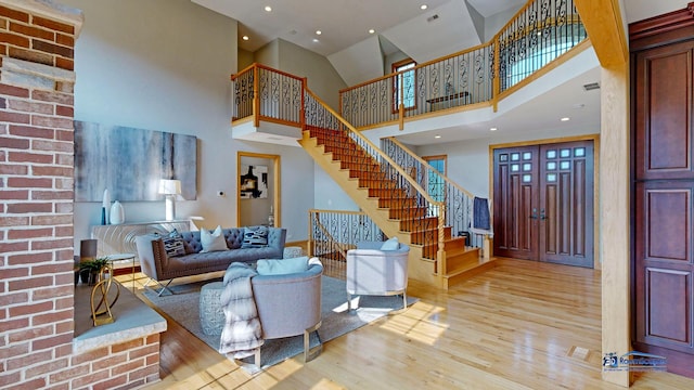 19113 Lauren Ln, Marengo, IL 60152 - living room with light wood-style floors, a towering ceiling, and stairs