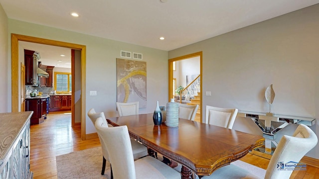 19113 Lauren Ln, Marengo, IL 60152 - dining space featuring light wood finished floors, stairway, and recessed lighting