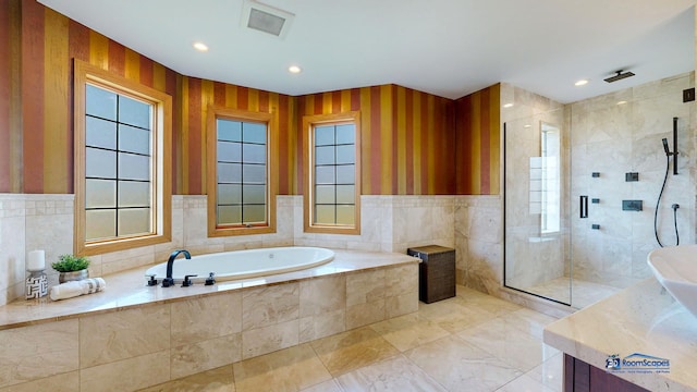 19113 Lauren Ln, Marengo, IL 60152 - bathroom featuring a bath, a stall shower, tile walls, recessed lighting, and a wainscoted wall