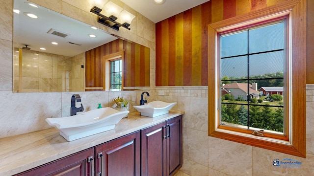 19113 Lauren Ln, Marengo, IL 60152 - full bathroom featuring double vanity, tile walls, a tile shower, and recessed lighting