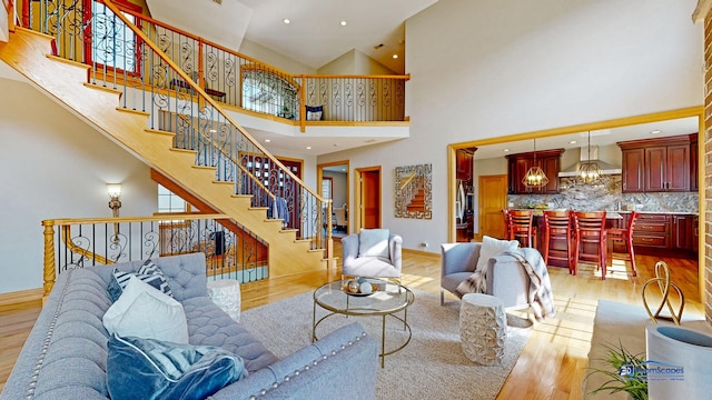 19113 Lauren Ln, Marengo, IL 60152 - living area with high vaulted ceiling, light wood finished floors, stairs, and recessed lighting