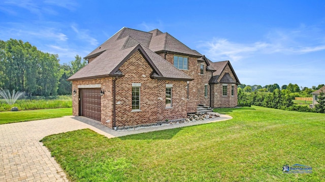 19113 Lauren Ln, Marengo, IL 60152 - view of side of property with brick siding, a lawn, driveway, and a garage