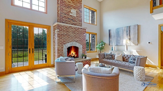 19113 Lauren Ln, Marengo, IL 60152 - living room with a high ceiling, french doors, wood finished floors, and a brick fireplace