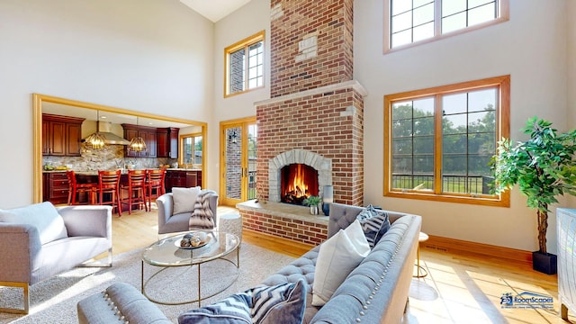 19113 Lauren Ln, Marengo, IL 60152 - living area with high vaulted ceiling, light wood finished floors, and a fireplace