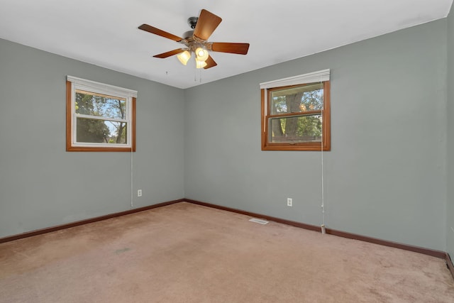 955 E 5th St, Coal City, IL 60416 - empty room with plenty of natural light, light colored carpet, and ceiling fan