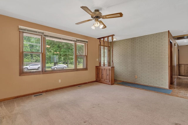 955 E 5th St, Coal City, IL 60416 - carpeted spare room featuring ceiling fan and brick wall