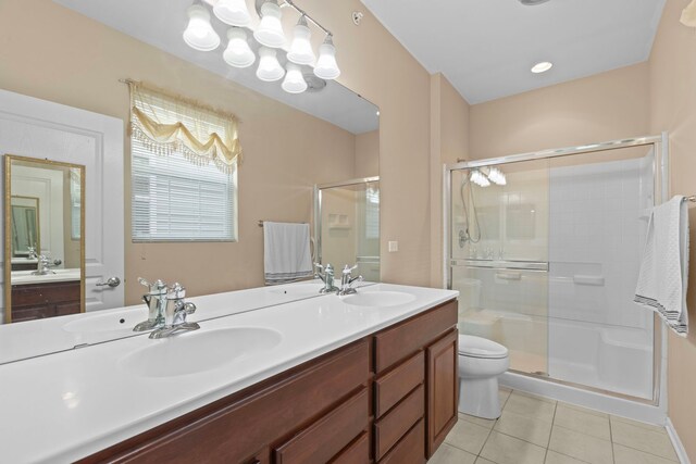 14300 Sundance Dr, Huntley, IL 60142 - bathroom featuring tile patterned flooring, a stall shower, and double vanity