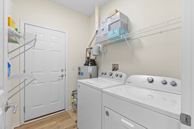 14300 Sundance Dr, Huntley, IL 60142 - washroom featuring washing machine and clothes dryer and light wood-style flooring