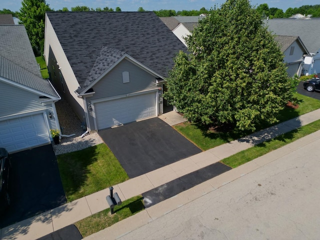 14300 Sundance Dr, Huntley, IL 60142 - view of front facade with driveway, a shingled roof, and an attached garage