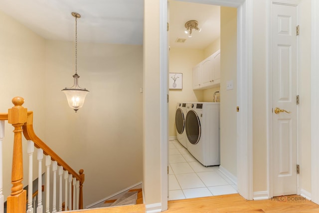 1804 Monroe Ct, Glenview, IL 60025 - laundry area featuring independent washer and dryer, cabinet space, and light tile patterned floors