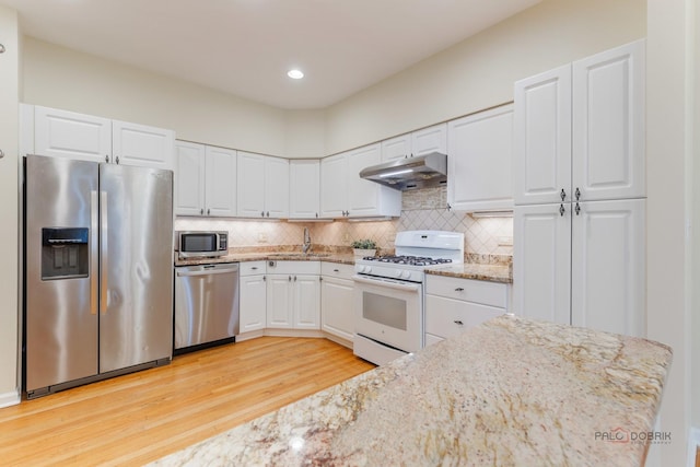1804 Monroe Ct, Glenview, IL 60025 - kitchen with appliances with stainless steel finishes, under cabinet range hood, light wood-type flooring, white cabinetry, and decorative backsplash