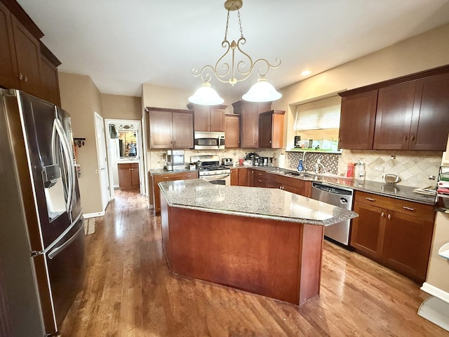 38422 N Adams St, Lake Villa, IL 60046 - kitchen with stainless steel appliances, wood finished floors, a center island, and backsplash