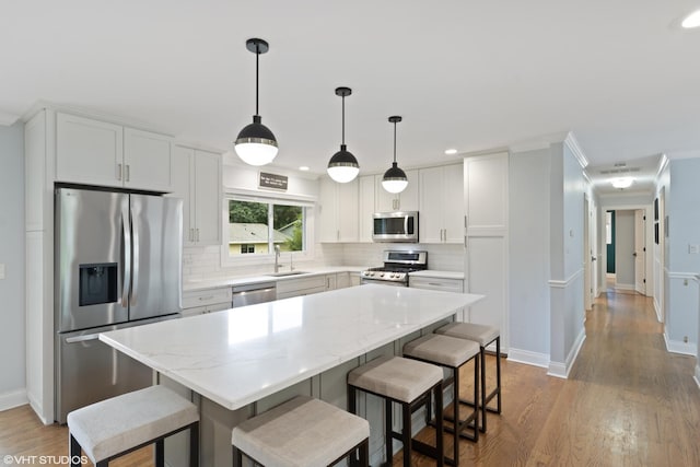 1217 E Pratt Dr, Palatine, IL 60074 - kitchen featuring stainless steel appliances, tasteful backsplash, a kitchen bar, and recessed lighting