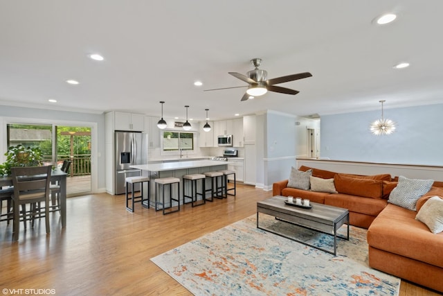 1217 E Pratt Dr, Palatine, IL 60074 - living room with recessed lighting, ceiling fan, light wood-type flooring, ornamental molding, and a chandelier