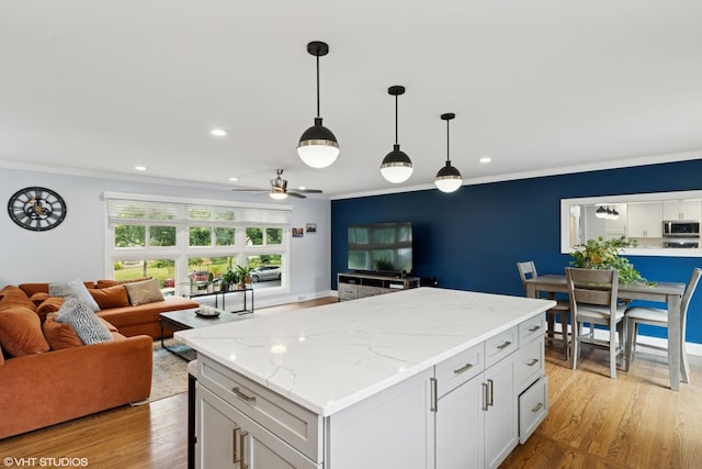 1217 E Pratt Dr, Palatine, IL 60074 - kitchen with stainless steel microwave, open floor plan, ornamental molding, a ceiling fan, and hanging light fixtures