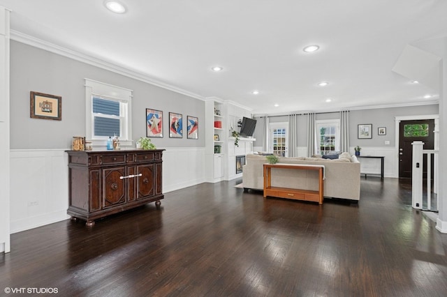 5106 W Eddy St, Chicago, IL 60641 - living area with crown molding, dark wood-style flooring, recessed lighting, wainscoting, and built in shelves