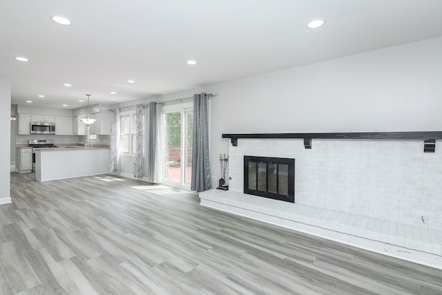 1557 Scottdale Cir, Wheaton, IL 60189 - unfurnished living room featuring recessed lighting, a fireplace, and light wood-style flooring