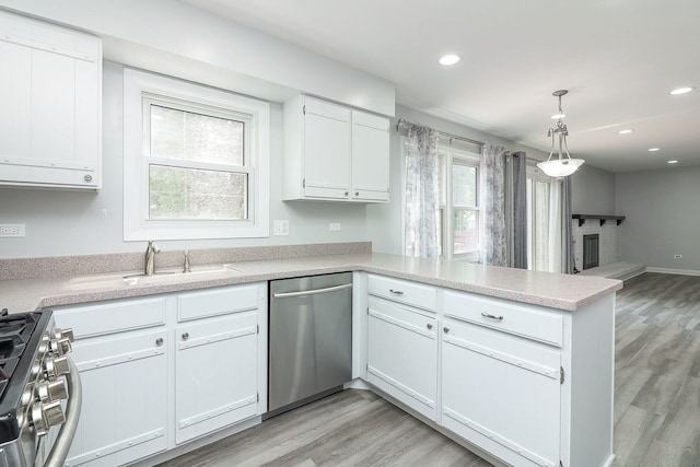 1557 Scottdale Cir, Wheaton, IL 60189 - kitchen featuring stainless steel appliances, a peninsula, light countertops, recessed lighting, and white cabinetry