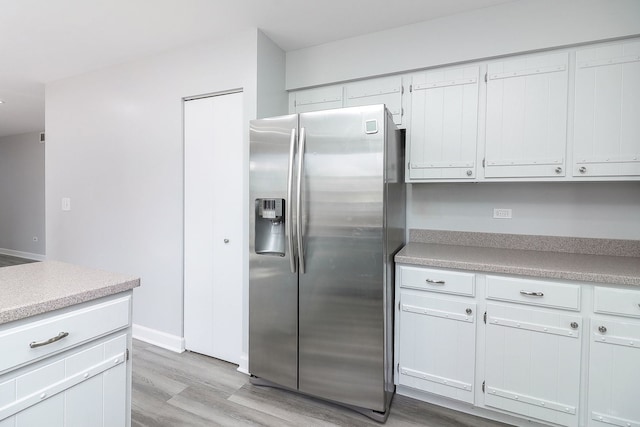 1557 Scottdale Cir, Wheaton, IL 60189 - kitchen featuring stainless steel fridge, light wood-style flooring, light countertops, and white cabinets