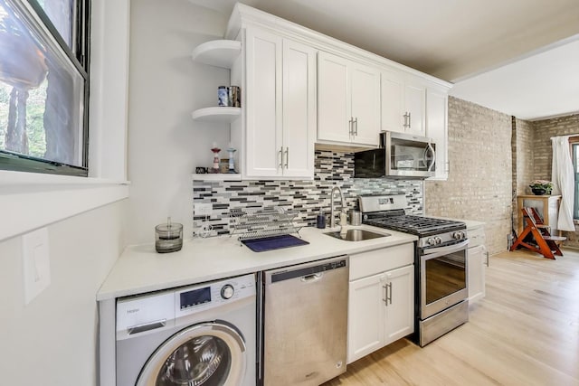 7021 N Sheridan Rd Unit 1, Chicago, IL 60626 - kitchen featuring stainless steel appliances, washer / dryer, open shelves, and plenty of natural light
