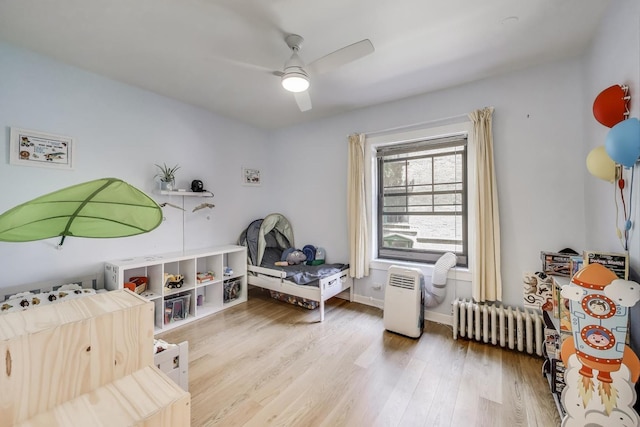 7021 N Sheridan Rd Unit 1, Chicago, IL 60626 - game room featuring radiator, wood finished floors, and ceiling fan