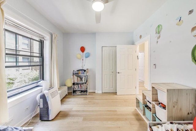 7021 N Sheridan Rd Unit 1, Chicago, IL 60626 - bedroom featuring multiple windows, light wood-style flooring, a closet, and a ceiling fan