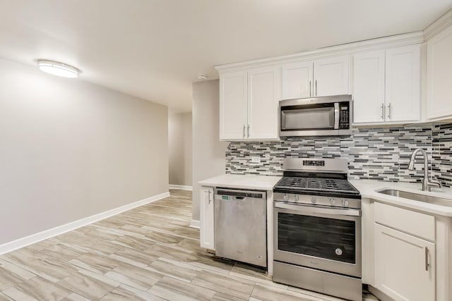 7021 N Sheridan Rd Unit 1, Chicago, IL 60626 - kitchen with stainless steel appliances, backsplash, light countertops, and white cabinets