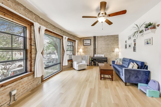 7021 N Sheridan Rd Unit 1, Chicago, IL 60626 - living room with brick wall, light wood-type flooring, radiator heating unit, and a ceiling fan